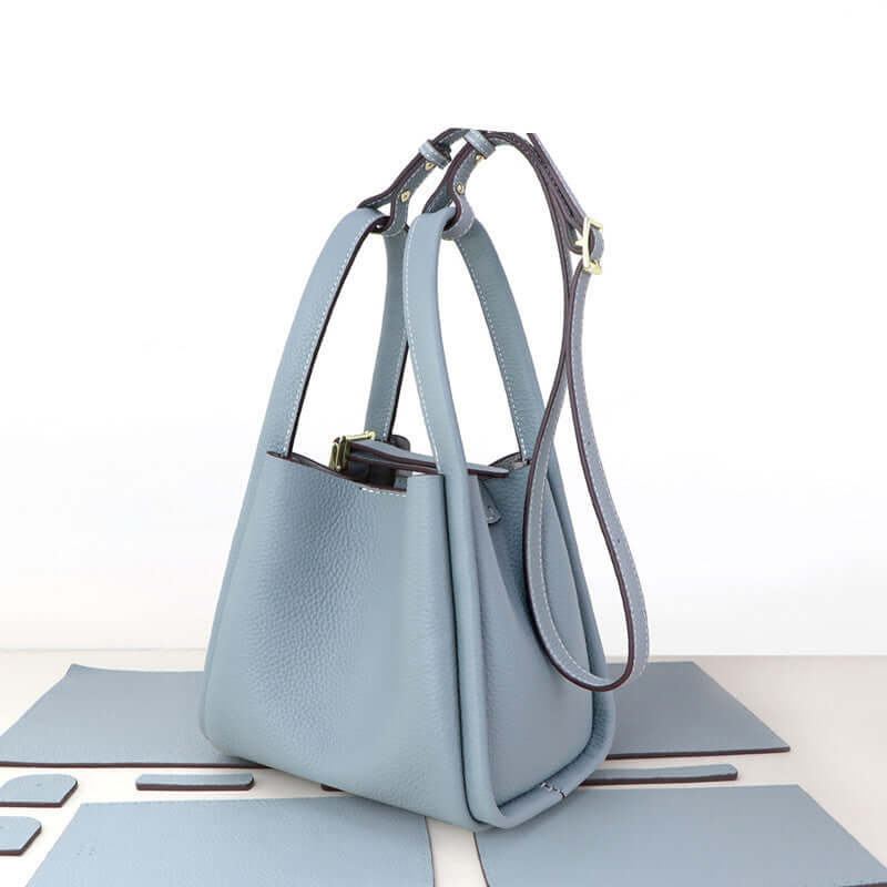 Make Your Own Leather Bags Hand Sewing Handmade Leather Goods - Stylish blue leather bag with adjustable straps.