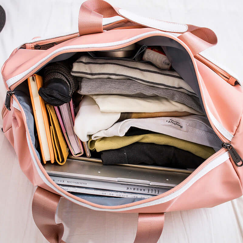 Hand-held large-capacity men's and women's body bags filled with clothes and accessories, showcasing their spacious interior.