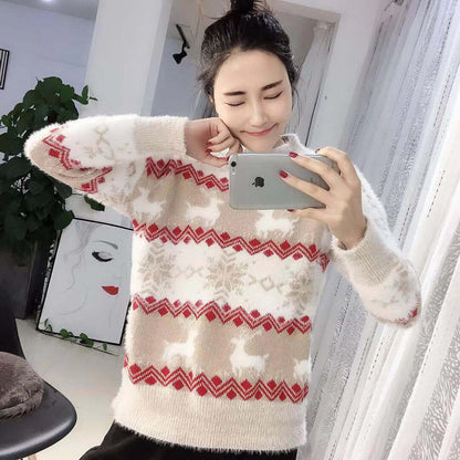 Snowflake deer pullover woman worn by a smiling woman in a cozy indoor setting, showcasing its casual design and soft fabric.
