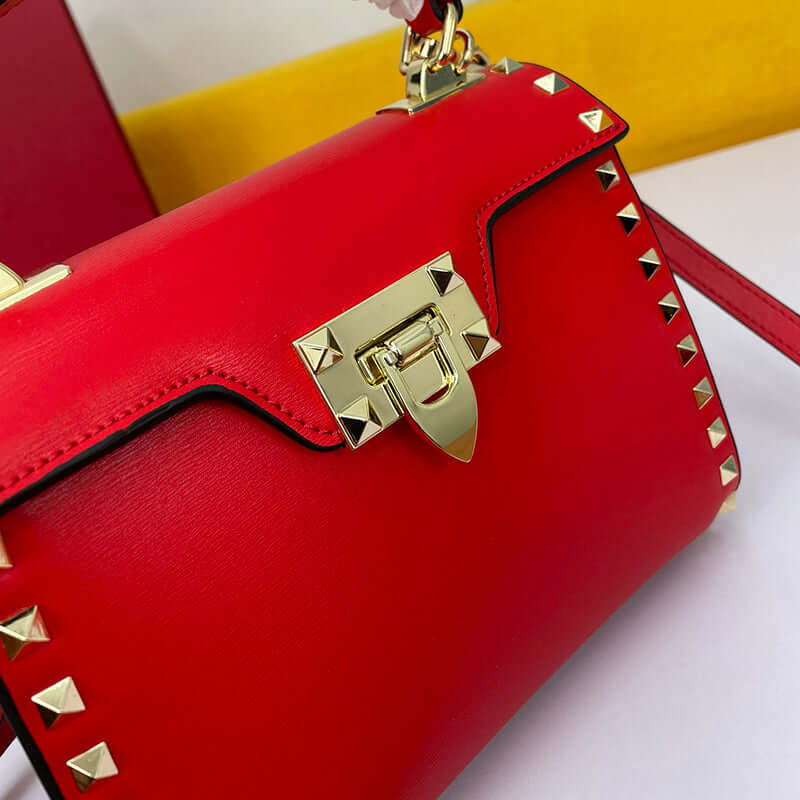 Cowhide Rivet-bound Women's Bag With Single-shoulder Messenger Pattern in red with gold details and rivets.