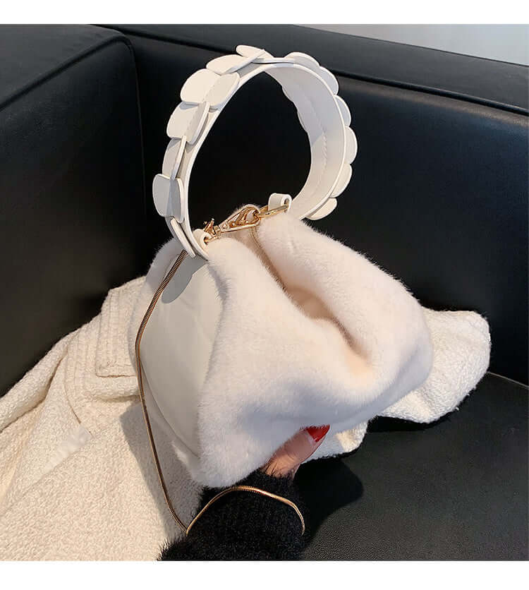 Autumn And Winter Small Furry Crossbody Hand Bag Female Bags displayed on a couch with a soft surface and stylish handle.