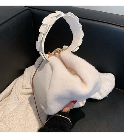 Autumn And Winter Small Furry Crossbody Hand Bag Female Bags displayed on a couch with a soft surface and stylish handle.
