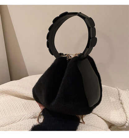 Autumn And Winter Small Furry Crossbody Hand Bag Female Bags held in hand on textured blanket.