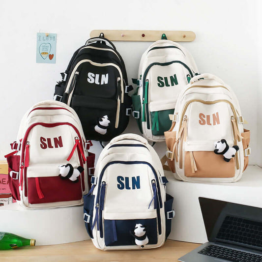 Large Oxford Travel Backpack With Dirt-Resistant Design in various colors displayed on a table.