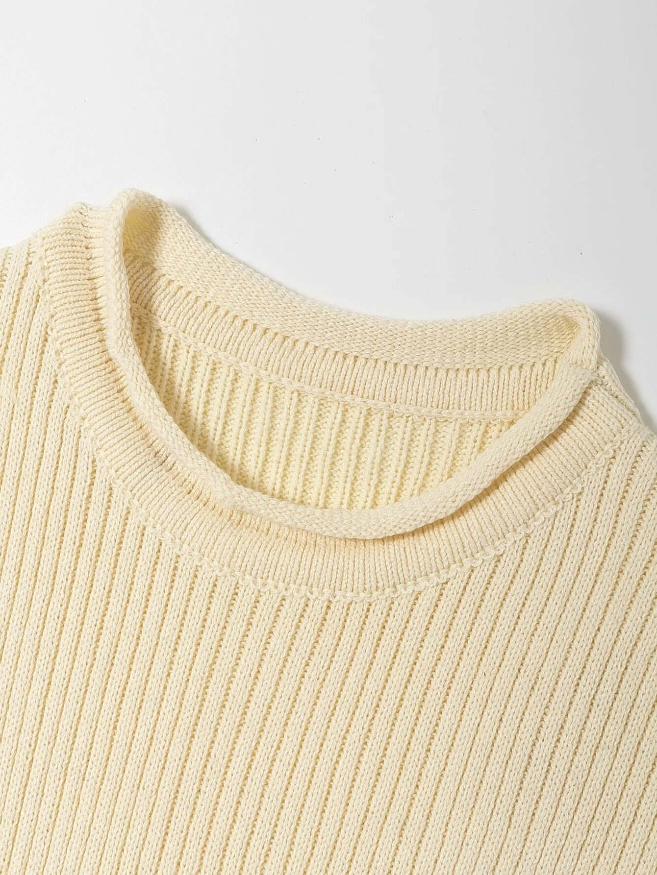 Knitwear top vest woman - close-up of ribbed knit texture and collar in light yellow color.