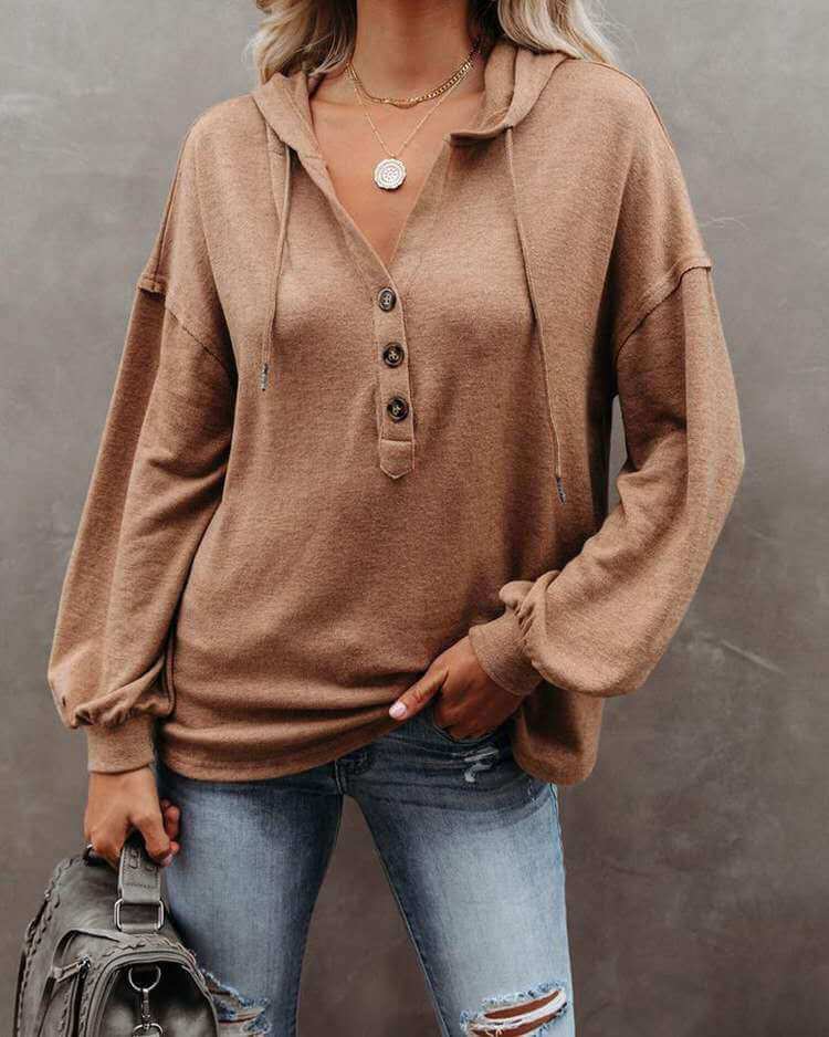 Autumn and Winter Solid Color Loose Hooded Woman in brown with buttons, styled casually with jeans.