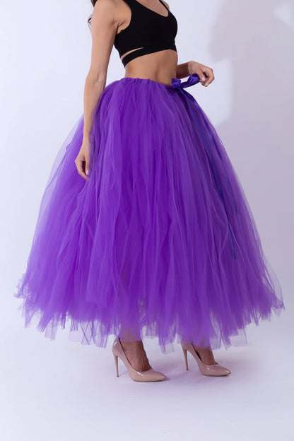 Pregnant woman dress displayed on model wearing a purple tulle skirt with a bow detail.