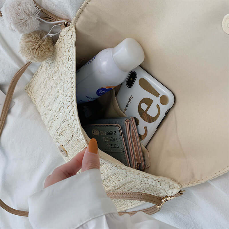New style hand woven bags in summer, showing interior contents including a phone, wallet, and cosmetic bottle.