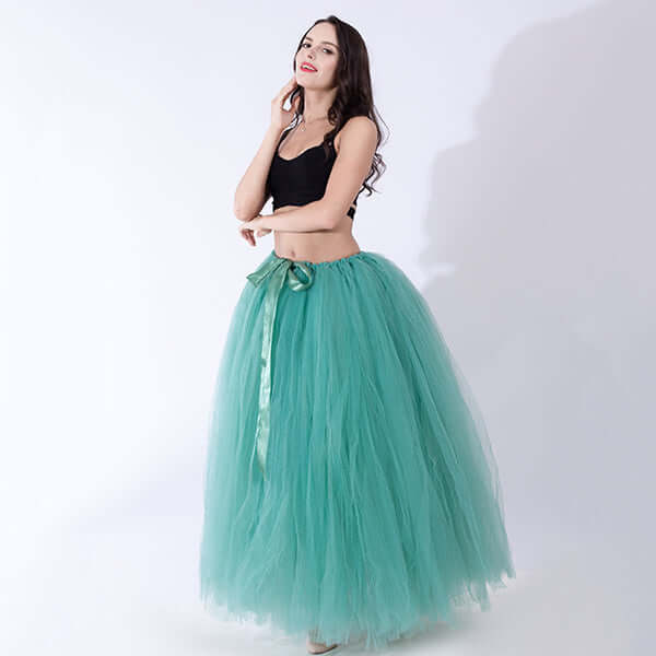 Pregnant woman dress in teal tulle with black top, perfect for maternity and special occasions.