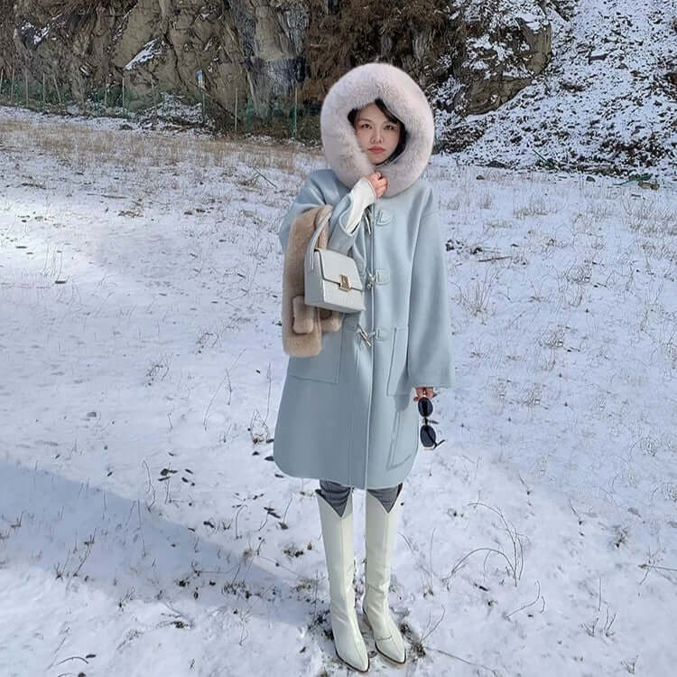 Crocodile-Pattern Leather Handbag – Versatile Carry held by a woman in a winter coat in snowy landscape.