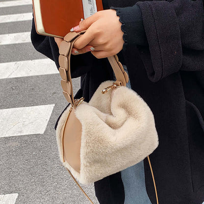 Autumn And Winter Small Furry Crossbody Hand Bag Female Bags held by a woman on a city street.