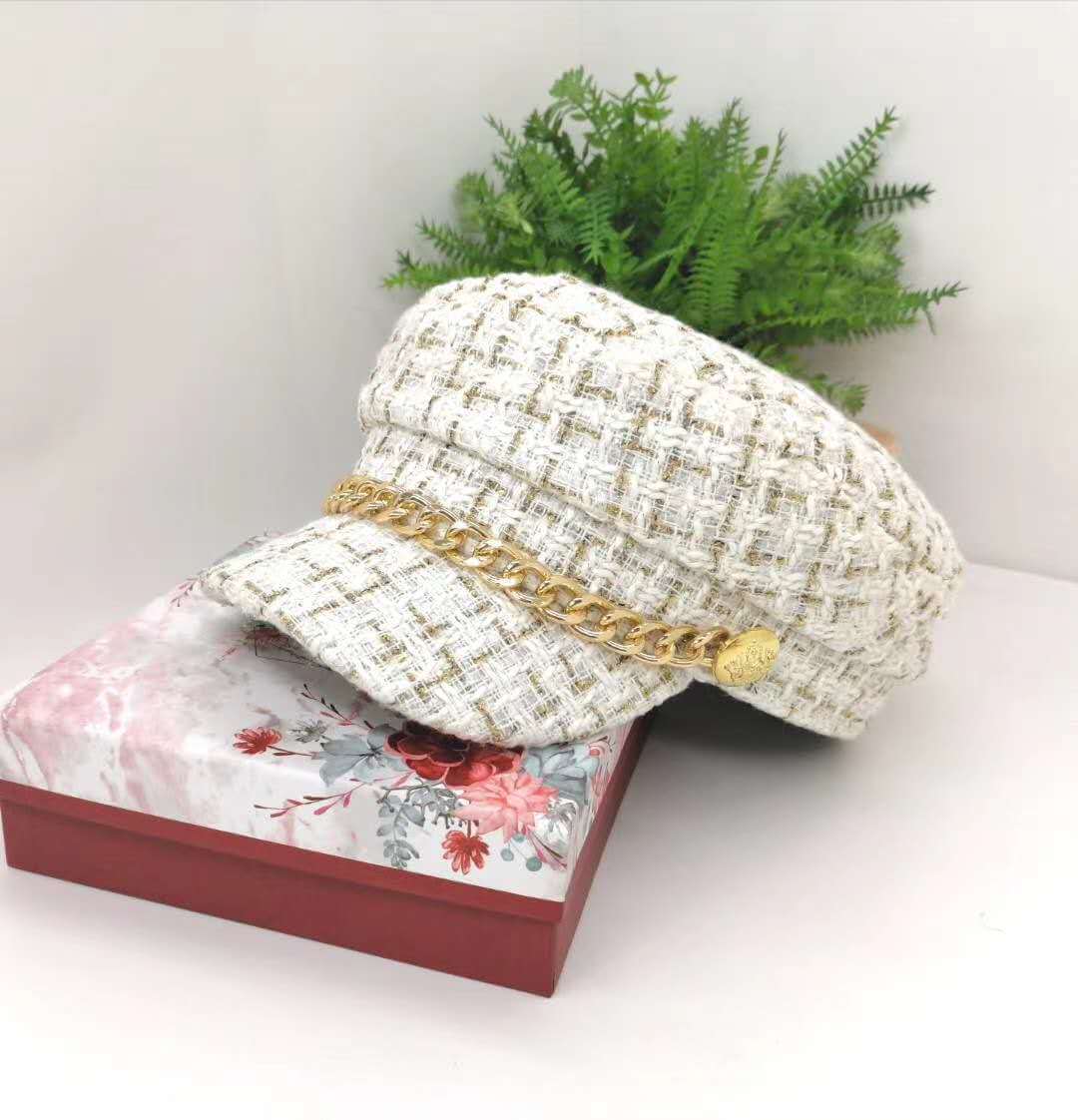 Vintage Little Incense Style Tweed Navy Hat Octagonal Hat Woman displayed on a floral notebook with greenery in the background.