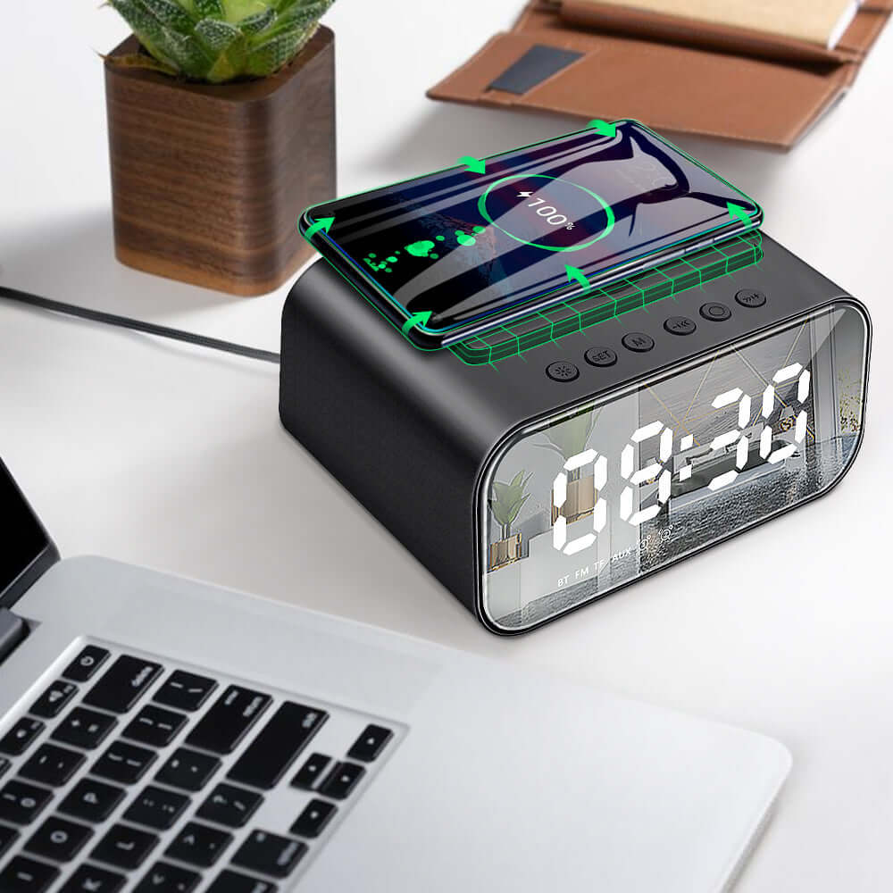 Wireless Charging Bluetooth Speaker Clock Led Alarm Clock Audio Wireless Charging Bluetooth Speaker on a desk with a smartphone.