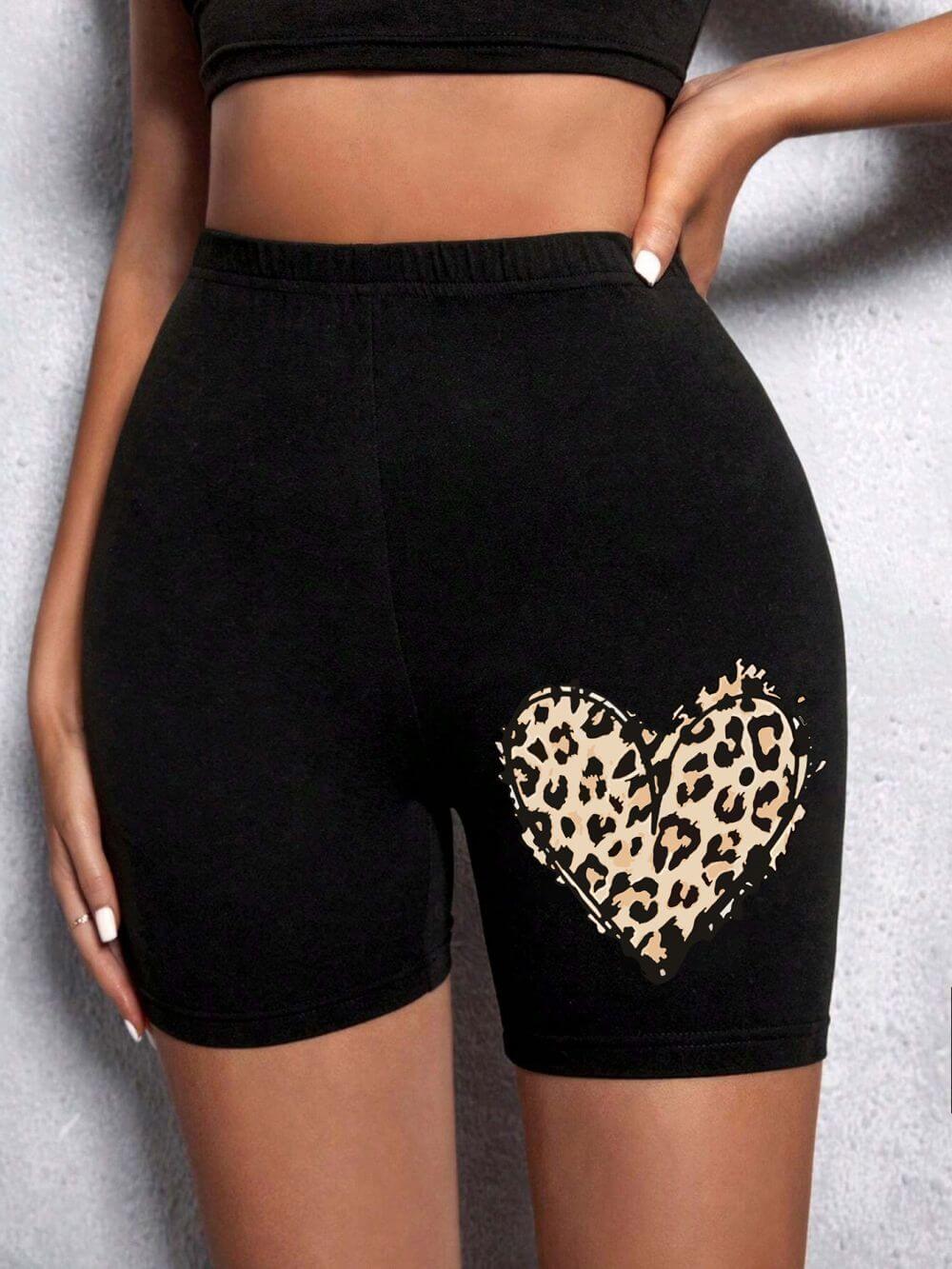 Summer Woman Tight Shorts Leopard Heart And Love Letter Grap featuring a leopard print heart design on black fabric.