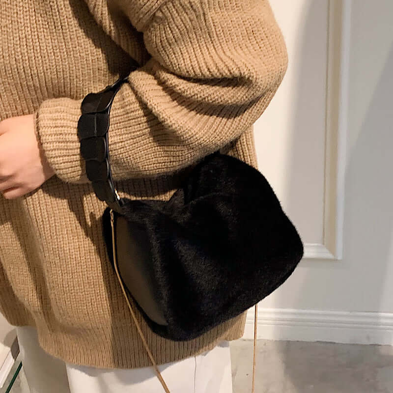 Autumn And Winter Small Furry Crossbody Hand Bag Female Bags in black held by a person wearing a beige sweater.