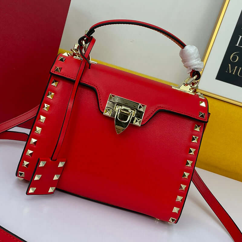 Cowhide Rivet-bound Women's Bag With Single-shoulder Messenger Pattern in bright red with gold studs and clasp.