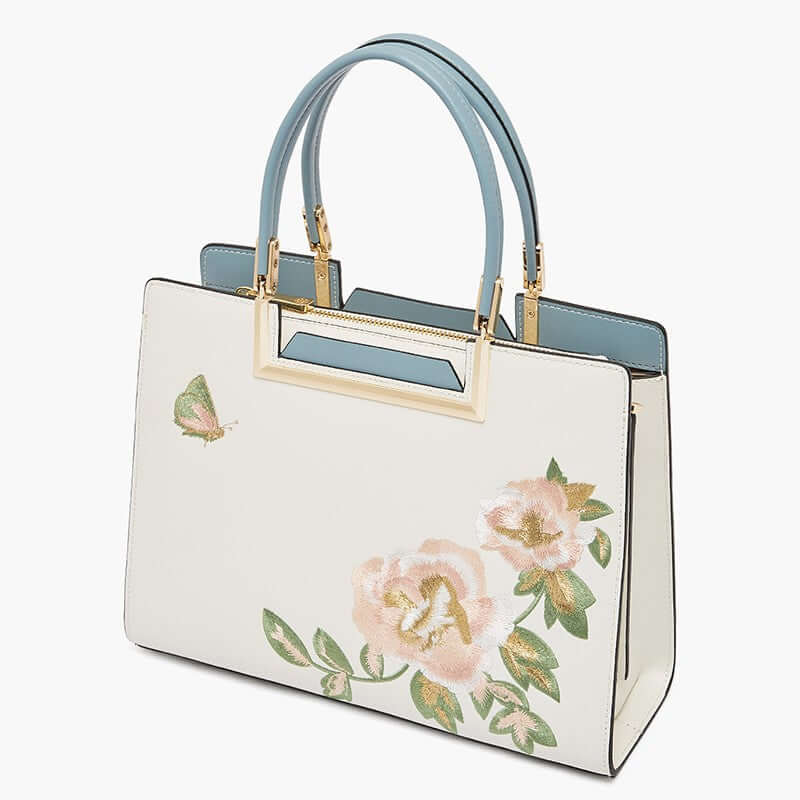 Fashion Embroidered Crossbody Bag Women with floral embroidery, elegant design, and blue handles.