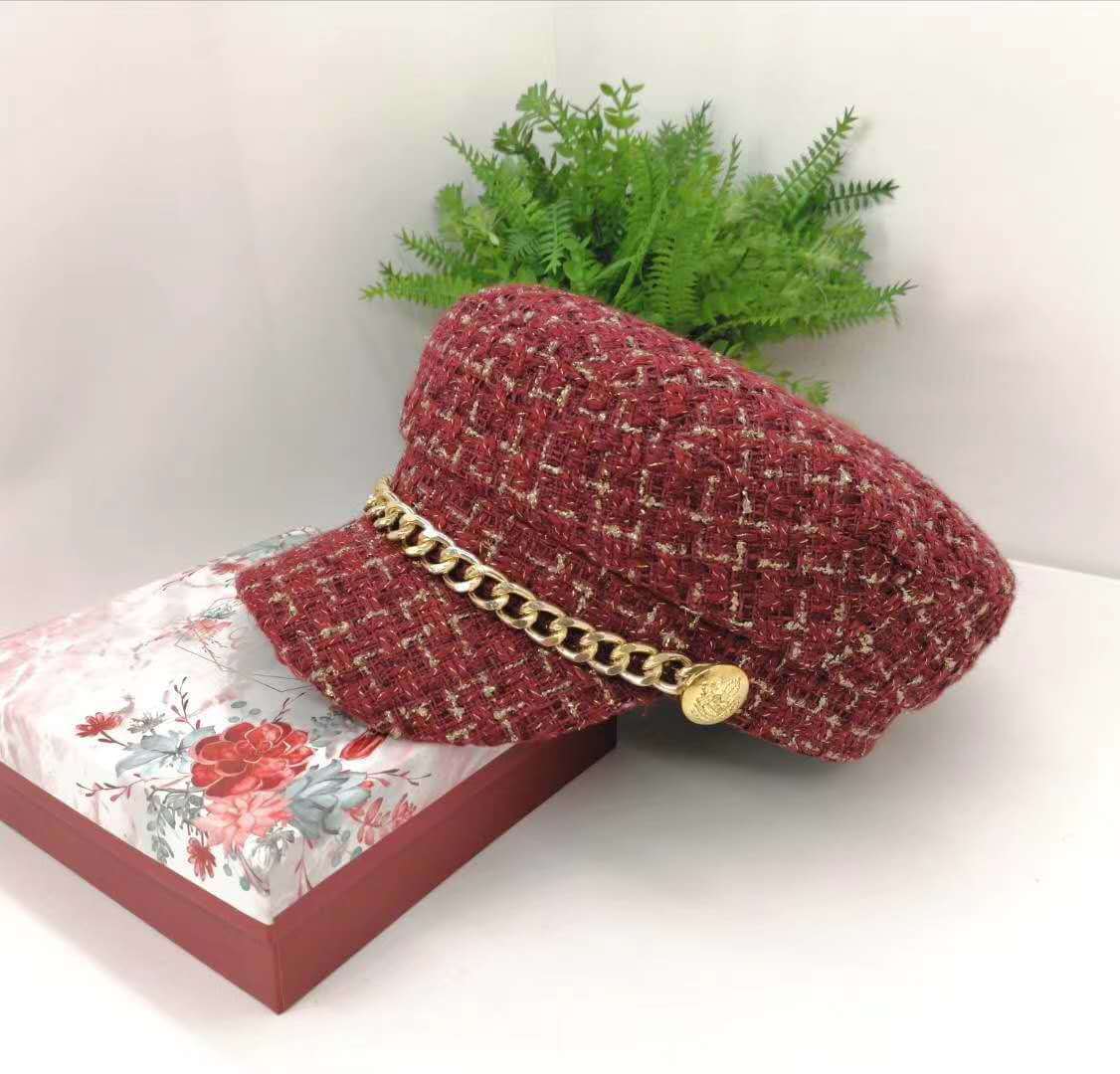 Vintage Little Incense Style Tweed Navy Hat Octagonal Hat Woman displayed on a floral box with greenery in the background.
