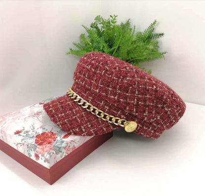 Vintage Little Incense Style Tweed Navy Hat Octagonal Hat Woman displayed on a floral box with greenery in the background.