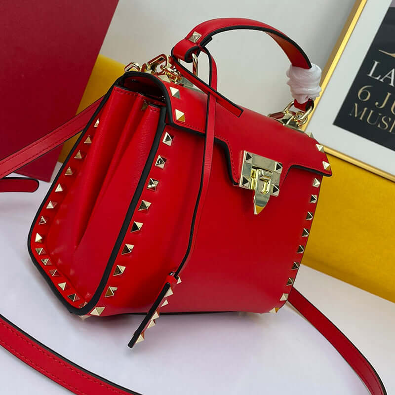 Cowhide Rivet-bound Women's Bag With Single-shoulder Messenger Pattern featuring red leather and gold rivets.