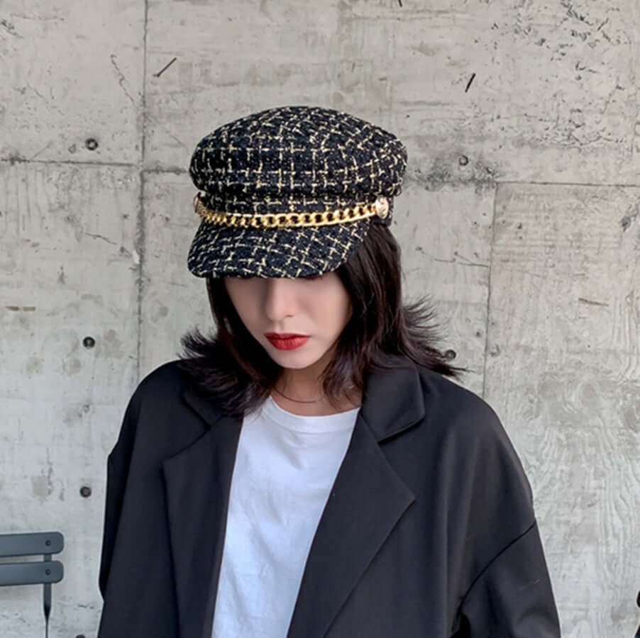 Vintage Little Incense Style Tweed Navy Hat Octagonal Hat Woman worn by a model with a modern outfit against a concrete backdrop.