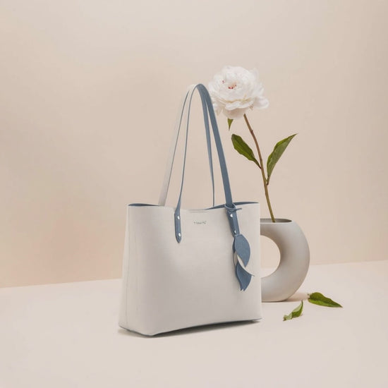 Women’s Leather Shell Handbag – Large Capacity Tote displayed with flower arrangement.
