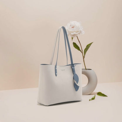 Women’s Leather Shell Handbag – Large Capacity Tote displayed with flower arrangement.